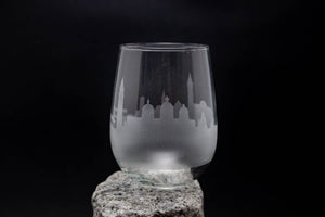 a glass sitting on top of a rock