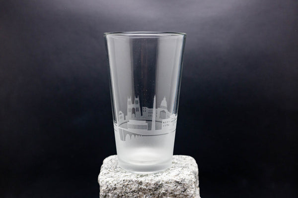 a tall glass sitting on top of a rock