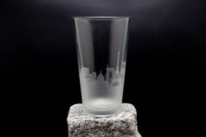 a tall glass sitting on top of a rock