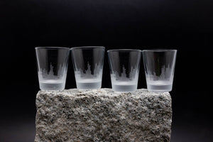 four glasses sitting on top of a rock