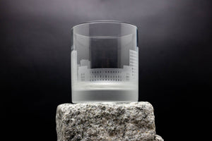 a glass sitting on top of a rock