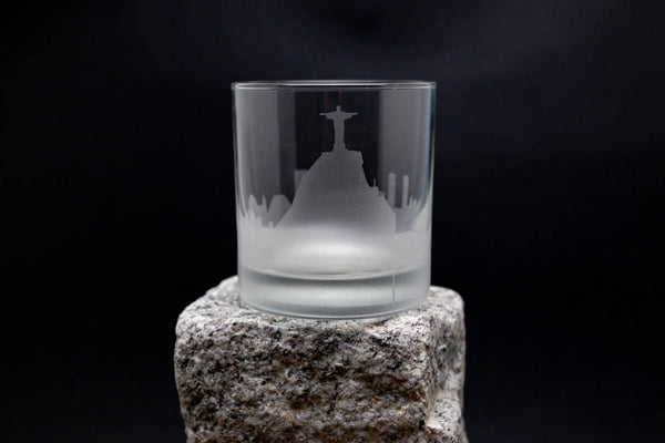 a glass sitting on top of a rock