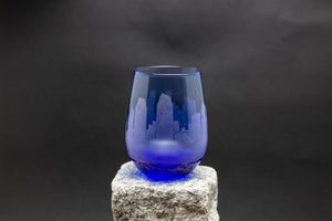 a blue glass sitting on top of a rock