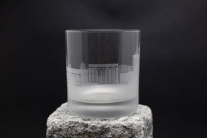 a glass sitting on top of a rock