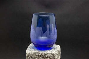 a blue glass sitting on top of a rock