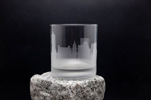 a glass sitting on top of a rock