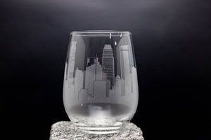 a glass with a city skyline etched on it