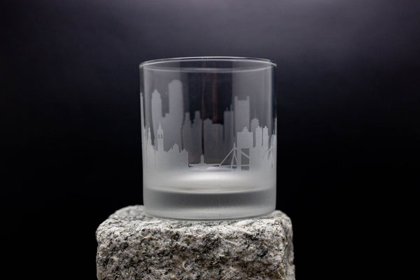 a glass sitting on top of a rock