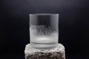 a glass sitting on top of a rock