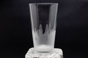 a tall glass sitting on top of a rock