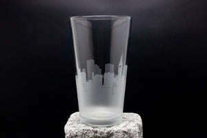 a tall glass sitting on top of a rock