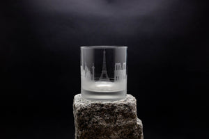 a shot glass sitting on top of a rock