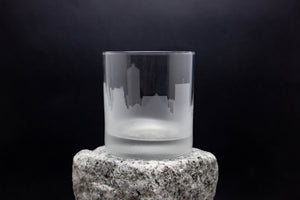 a glass sitting on top of a rock