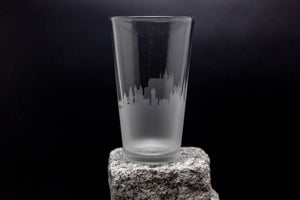 a tall glass sitting on top of a rock