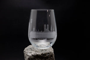 a wine glass sitting on top of a rock