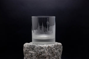 a shot glass sitting on top of a rock