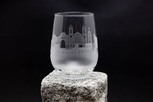 a glass sitting on top of a rock