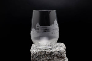 a glass sitting on top of a rock