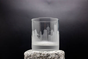 a glass with a city skyline etched on it