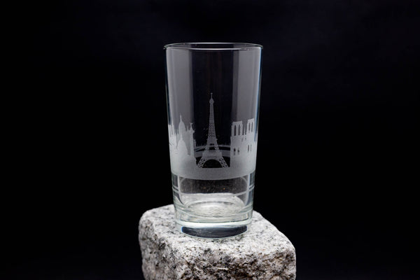 a shot glass sitting on top of a rock