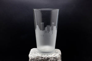 a tall glass sitting on top of a rock