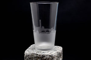 a tall glass sitting on top of a rock