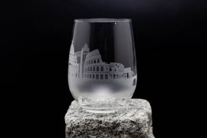 a clear glass sitting on top of a rock