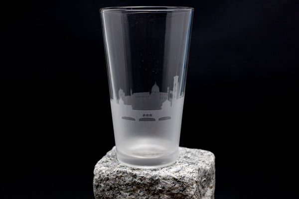 a shot glass sitting on top of a rock