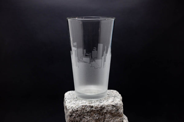 a tall glass sitting on top of a rock