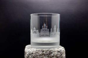 a glass with a castle etched on it