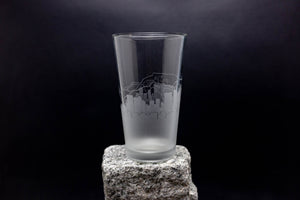 a tall glass sitting on top of a rock