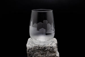 a glass sitting on top of a rock