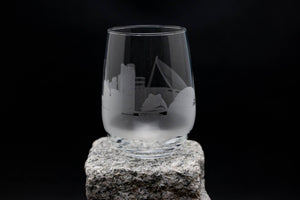 a glass sitting on top of a rock