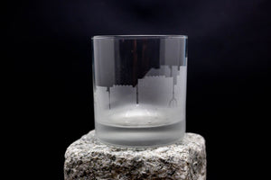 a glass sitting on top of a rock