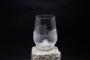 a glass sitting on top of a rock