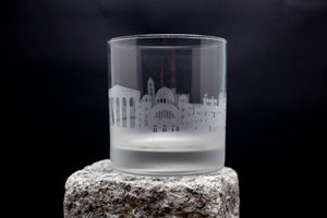 a shot glass sitting on top of a rock