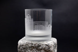 a shot glass sitting on top of a rock