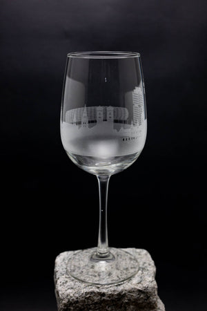 a wine glass sitting on top of a rock