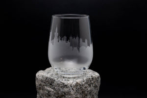 a glass sitting on top of a rock