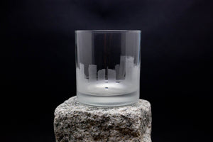 a glass sitting on top of a rock