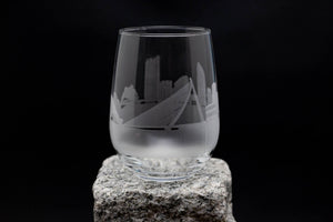 a glass with a city skyline etched on it