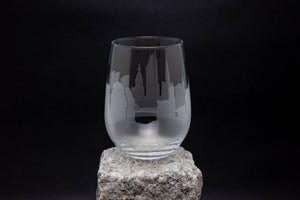 a glass sitting on top of a rock