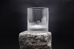 a glass sitting on top of a rock