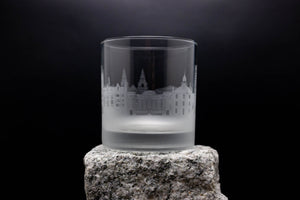 a shot glass sitting on top of a rock