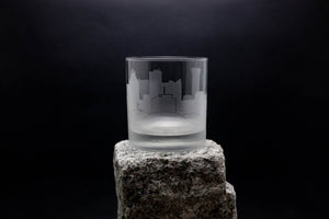 a glass sitting on top of a rock