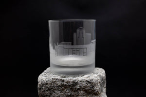 a glass sitting on top of a rock