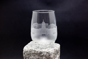 a glass sitting on top of a rock