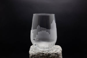 a clear glass sitting on top of a rock