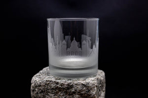 a shot glass sitting on top of a rock