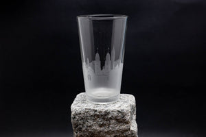 a tall glass sitting on top of a rock